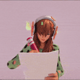 a girl wearing headphones and a green sweater
