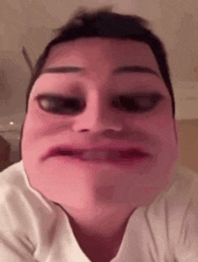 a close up of a man 's face with a pink mask on it .