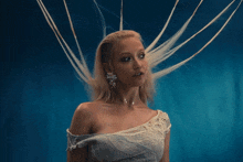a woman in a white dress has a nose ring on her lip