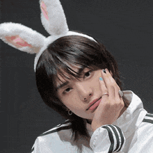 a man wearing bunny ears and a ring on his finger