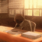 a man is sitting at a desk with his head in his hands