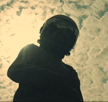 a silhouette of a person wearing a helmet
