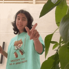 a person wearing a t-shirt with a fox on it pointing