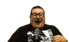 a man wearing glasses is standing in front of a microphone and making a funny face .