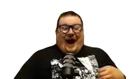 a man wearing glasses is standing in front of a microphone and making a funny face .
