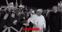 a black and white photo of a man in a white robe surrounded by people with a caption that says aahhhhaaa