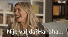 a woman is laughing with the words nije valida ? hahaha written below her