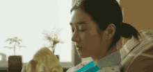 a woman is laying in a hospital bed holding a blanket
