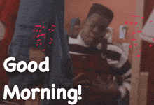 a man in a striped shirt is singing a song with the words good morning behind him