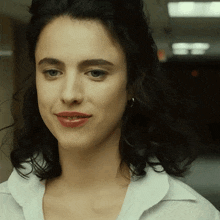 a close up of a woman 's face with dark hair