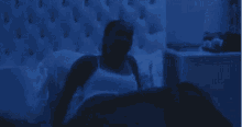a man is laying in a bed with a nightstand in the background .