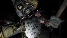 a close up of a machine with a yellow eye and a black background