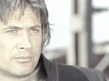 a close up of a man 's face with a serious expression .