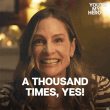 a woman is smiling with the words " a thousand times yes " in front of her