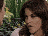 a man and woman are looking at each other and the woman is making a funny face