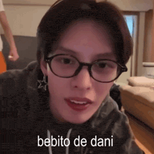 a close up of a person wearing glasses with the words bebito de dani below them