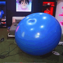 a blue ball with a picture of monkey d luffy on the wall