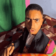 a man with a surprised look on his face is laying on a blanket