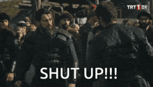 a group of men are standing in a field with the words shut up written on the bottom