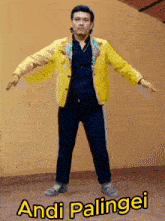 a man in a yellow jacket and blue pants with the name andi palingei below him