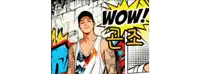 a man with a tattoo on his arm is standing in front of a wall with the word wow written on it