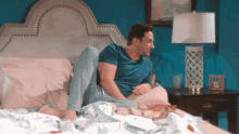 a man is laying on a bed with his legs crossed