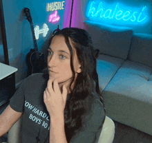 a woman wearing a t-shirt that says ' ow hard boys ' on it