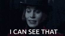 a black and white photo of a man wearing a top hat with the words `` i can see that '' below him .