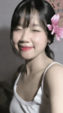 a girl with a pink flower in her hair