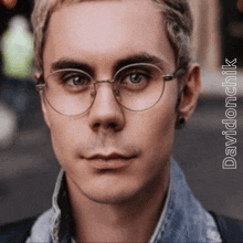 a close up of a man 's face with glasses and the name davidonchik on the bottom