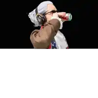 a man wearing headphones and sunglasses is holding a can of dr pepper