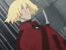a man with blonde hair and a red jacket holds a knife