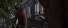 a man with a beard is holding a bow and arrows