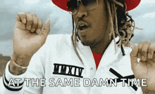 a man wearing sunglasses and a hat says at the same damn time