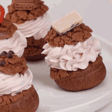 a close up of a cupcake with whipped cream and chocolate chips on top