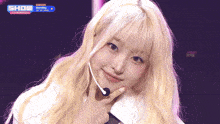 a woman with blonde hair and a show champion logo on the bottom right