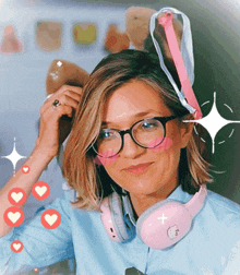 a woman wearing glasses and pink headphones has a pink bunny ear on her head