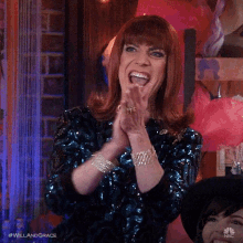 a woman in a blue sequined dress is clapping her hands while wearing a wig