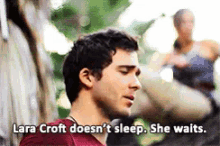 lara croft does n't sleep she waits says a man in a red shirt