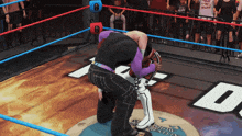 two wrestlers are in a wrestling ring with a sign that says sunset county wrestling