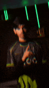 a man wearing a monster energy shirt is pointing