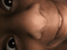 a close up of a baby 's face with a smile on his face