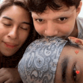 a man is kissing a woman 's forehead while wearing a paisley headband