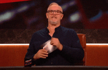 a man sitting at a table with a cup that says " bottle man "