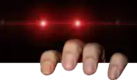 a person 's fingers are reaching out towards a red light behind them