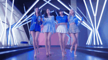 a group of girls standing on a stage holding pepsi bottles
