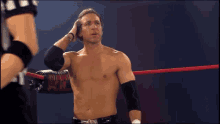 a shirtless wrestler stands in a wrestling ring with a sign that says heavyweight xxl on it