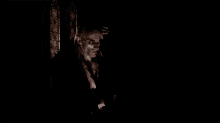 a man in a suit is standing in the dark with the word hola behind him