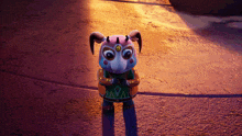 a stuffed animal with horns is wearing a green shirt with the letter l on it