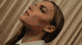 a close up of a woman 's face looking up at the sky